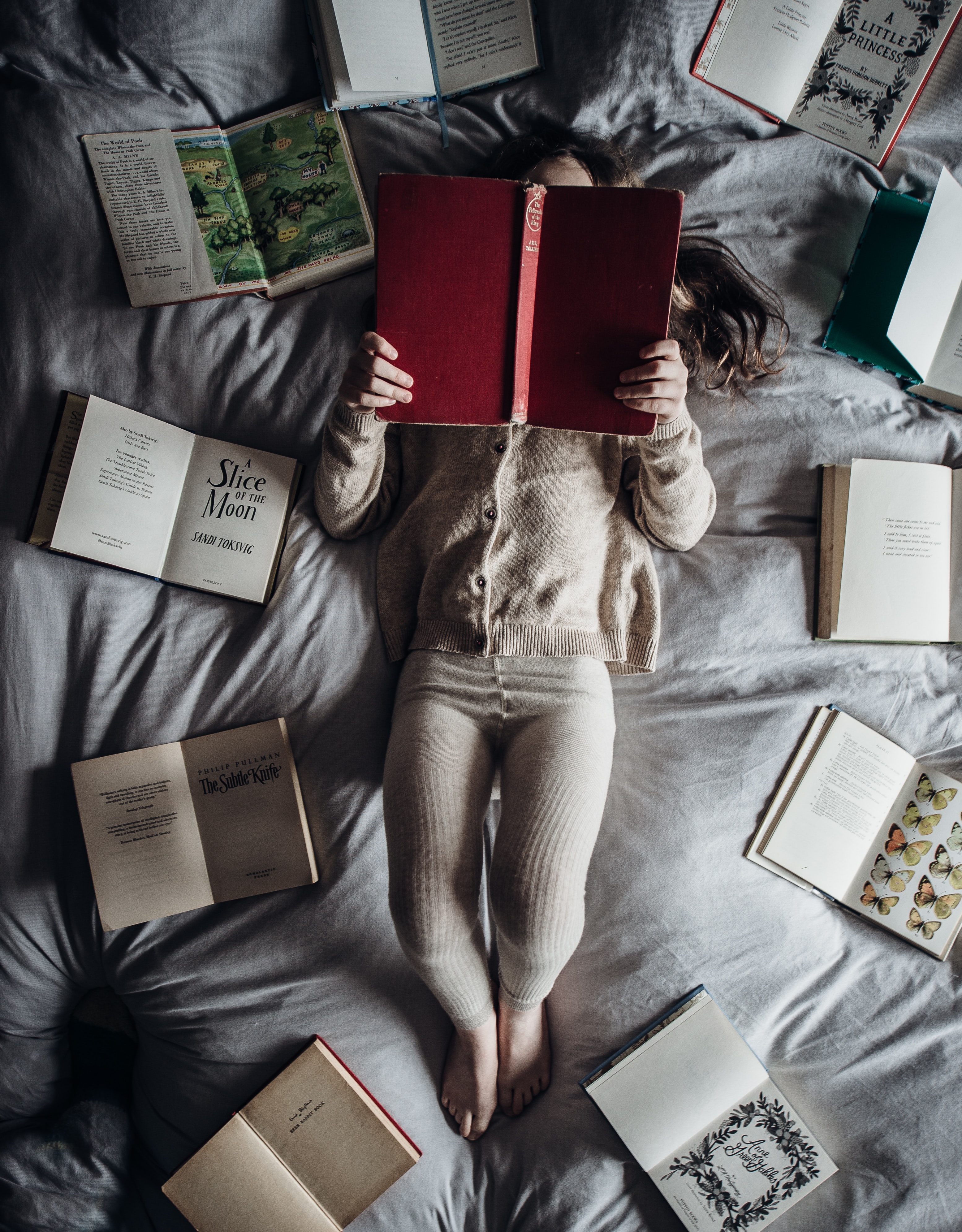 Young girl reading in bed